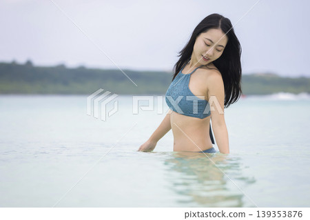 A woman in a swimsuit swimming in the sea off Miyako Island - travel image A woman in a swimsuit swimming in the sea off Miyako Island - travel image 139353876
