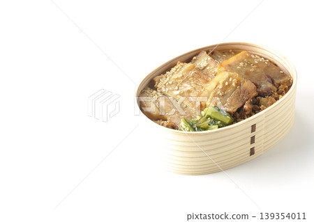 A photo of a grilled pork bento box against a white background. A photo of a grilled pork bento box against a white background. 139354011