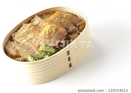 A photo of a grilled pork bento box against a white background. 139354013