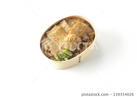 A photo of a grilled pork bento box against a white background. A photo of a grilled pork bento box against a white background. 139354026