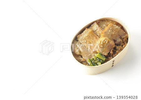 A photo of a grilled pork bento box against a white background. 139354028
