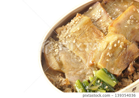 A photo of a grilled pork bento box against a white background. A photo of a grilled pork bento box against a white background. 139354036