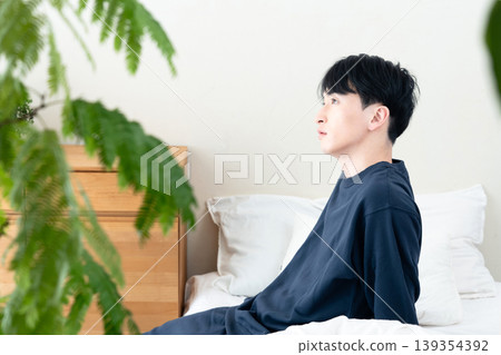 A young man who has just woken up feeling refreshed. A young man who has just woken up feeling refreshed. 139354392
