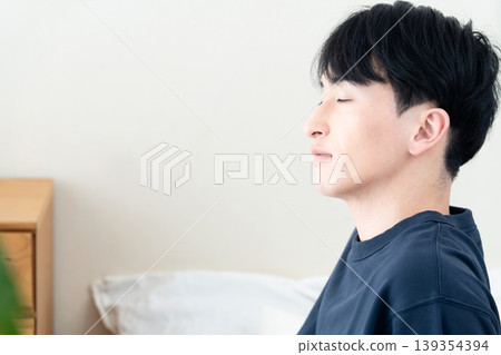 A young man who has just woken up feeling refreshed. A young man who has just woken up feeling refreshed. 139354394