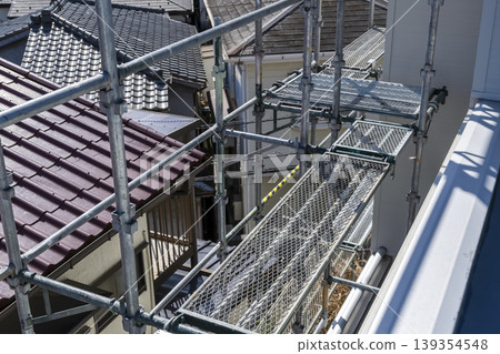A view overlooking the temporary scaffolding after a detached house renovation. A view overlooking the temporary scaffolding after a detached house renovation. 139354548