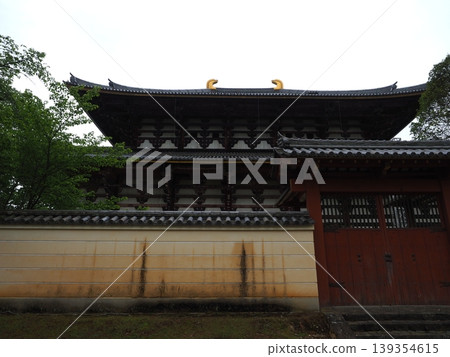 A view of the Todai-ji Temple's Great Buddha Hall from the rear. The beautiful joinery and roof finials supporting one of the world's largest wooden structures. A view of the Todai-ji Temple's Great Buddha Hall from the rear. The beautiful joinery and roof finials supporting one of the world's largest wooden structures. 139354615