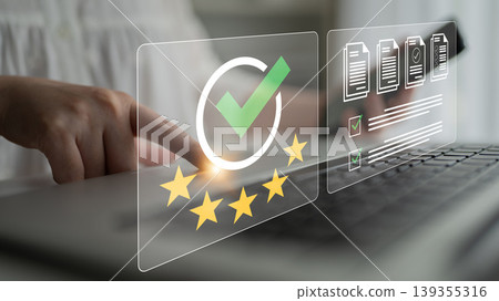 Woman Using Laptop with Digital Checkmark and Documents for Quality Assurance and Evaluation Process in Business Environment Ledger 139355316