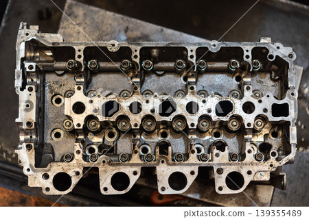 Close view of engine cylinder head with valves and ports showing mechanical components maintenance repair and automotive engineering workshop process 139355489