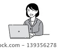 A young woman in a suit with a cheerful smile working on her computer; an office worker. 139356278