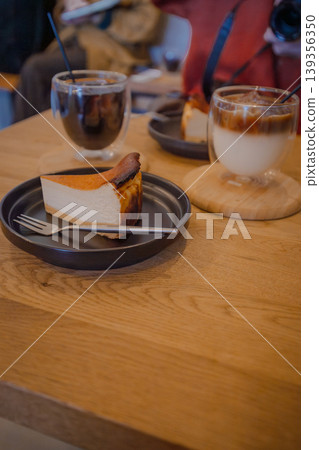 A popular dessert at the cafe: a set of rich Basque cheesecake and iced coffee. A popular dessert at the cafe: a set of rich Basque cheesecake and iced coffee. 139356350