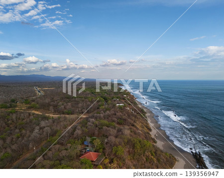 Coastline view with ocean waves and shore at sunset Coastline view with ocean waves and shore at sunset 139356947