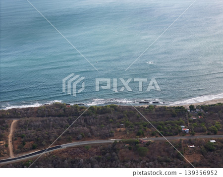 Coastline view from above near a road and water in daytime 139356952