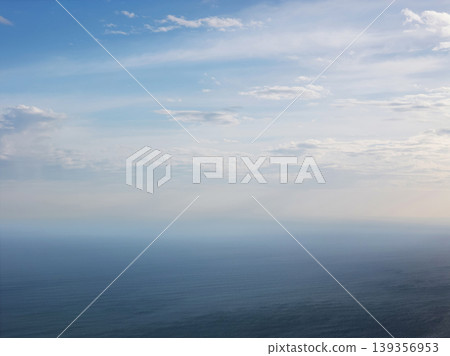 View of the ocean under a cloudy sky from a high place 139356953