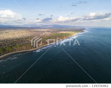 Coastline near the beach with waves and land in the distance Coastline near the beach with waves and land in the distance 139356962