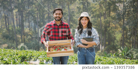 Two farmers stand in a vibrant green field Two farmers stand in a vibrant green field 139357386