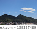 White clouds floating over summer mountains and residential areas 139357489