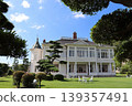Jinpukaku, its whiteness standing out against the backdrop of the summer blue sky and trees. 139357491