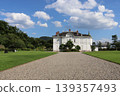 Jinpukaku stands out with its whiteness, surrounded by blue skies, trees, and lawns. 139357493