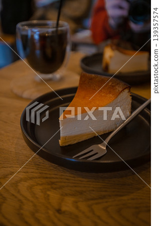 A popular dessert at the cafe: a set of rich Basque cheesecake and iced coffee. A popular dessert at the cafe: a set of rich Basque cheesecake and iced coffee. 139357574