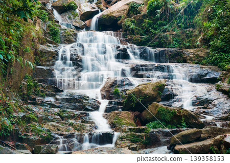 Waterfall cascading over rocky terrain in tropical forest at Vietnam Waterfall cascading over rocky terrain in tropical forest at Vietnam 139358153