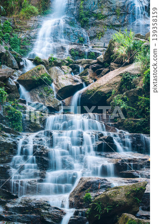 Waterfall cascading over rocky terrain in tropical forest at Vietnam Waterfall cascading over rocky terrain in tropical forest at Vietnam 139358159