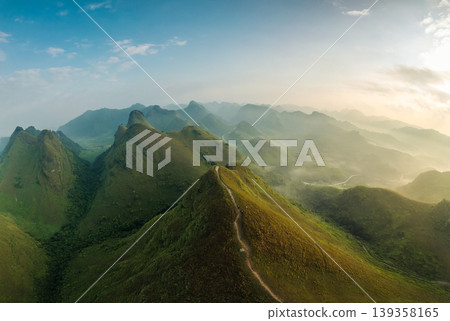 Scenery of Ba Guang grass hill, Mountain range with fog and villager bringing horse to graze on the mountain in the morning Scenery of Ba Guang grass hill, Mountain range with fog and villager bringing horse to graze on the mountain in the morning 139358165