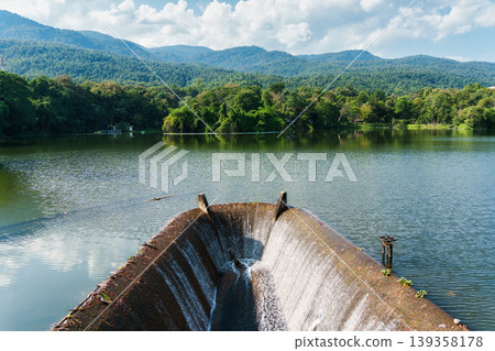 Reservoir flowing with tropical forest and blue sky in sunny day 139358178