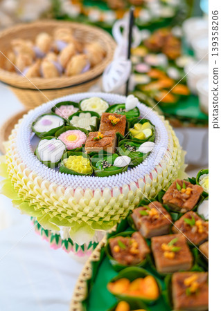Beautiful and appetizing traditional Thai desserts including crispy curry puffs, sweet treats and jelly desserts on dessert table Beautiful and appetizing traditional Thai desserts including crispy curry puffs, sweet treats and jelly desserts on dessert table 139358206