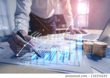 Business professional analyzing financial reports with growth charts, laptop, and coins, representing success and investment strategies in contemporary workspace Scalp Business professional analyzing financial reports with growth charts, laptop, and coins, representing success and investment strategies in contemporary workspace Scalp 139358285