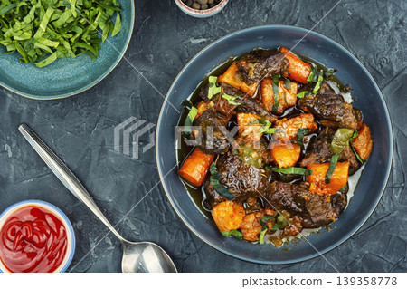 Braised beef with sweet potatoes Braised beef with sweet potatoes 139358778