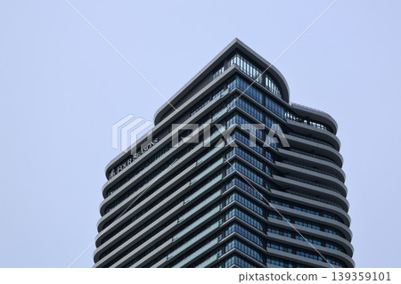 A tower apartment building and hotel in Dojima, Kita Ward, Osaka City, stand out against the blue sky. 139359101