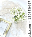 A bird's-eye view of white Orlaya flowers with a gold frame. 139359447