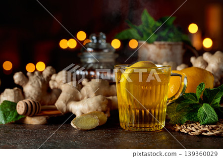 Cup of ginger tea with lemon, honey, mint, and ginger root. Cup of ginger tea with lemon, honey, mint, and ginger root. 139360029