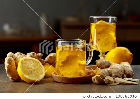 Ginger tea with lemon on a kitchen table. Ginger tea with lemon on a kitchen table. 139360030