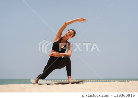 Fit woman practicing yoga on beach, outdoor Fitness and Healthy Lifestyle Concept. Fit woman practicing yoga on beach, outdoor Fitness and Healthy Lifestyle Concept. 139360919