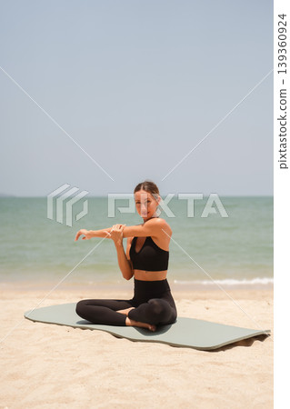 Fit woman practicing yoga on beach, outdoor Fitness and Healthy Lifestyle Concept. Fit woman practicing yoga on beach, outdoor Fitness and Healthy Lifestyle Concept. 139360924