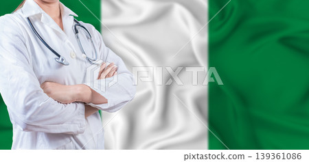 Doctor with crossed arms on Nigeria flag. Nigerian health and care concept. Female doctor on Nigeria flag 139361086