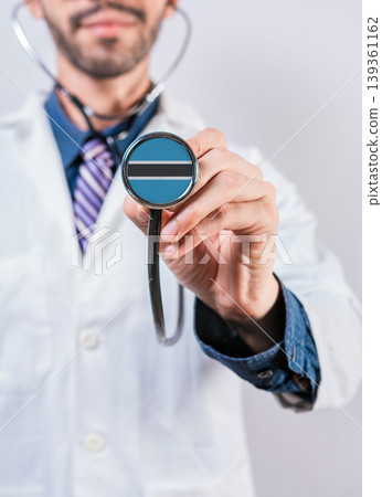 Botswana health and medical insurance concept. Botswana healthcare system, doctor holding stethoscope Botswana health and medical insurance concept. Botswana healthcare system, doctor holding stethoscope 139361162