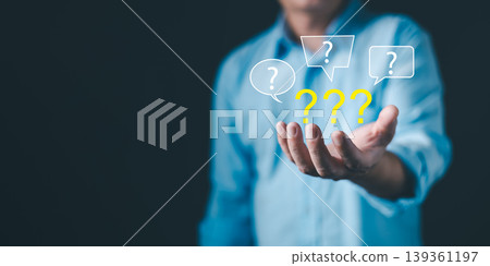 Businessman holding question marks floating above hand, symbolizing doubt, confusion, decision-making, problem solving, and brainstorming concept in business and communication. Businessman holding question marks floating above hand, symbolizing doubt, confusion, decision-making, problem solving, and brainstorming concept in business and communication. 139361197
