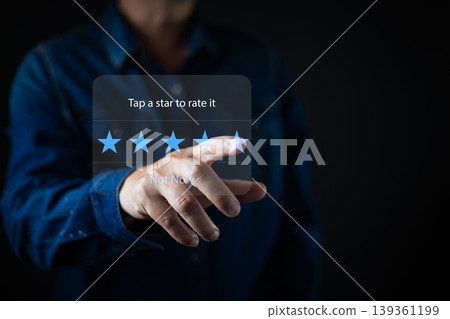 A person taps a bright virtual rating panel, choosing a five star review on a translucent interface that emphasizes modern feedback systems,user engagement,and intuitive digital interaction. A person taps a bright virtual rating panel, choosing a five star review on a translucent interface that emphasizes modern feedback systems,user engagement,and intuitive digital interaction. 139361199
