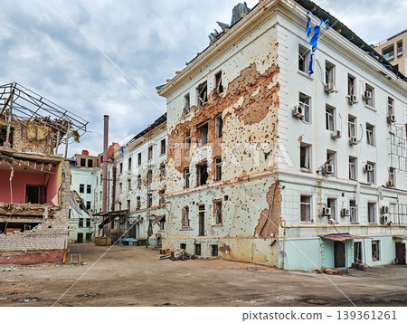 Civilian building damaged by shrapnel from ballistic missile explosion Civilian building damaged by shrapnel from ballistic missile explosion 139361261