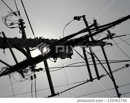 A landscape of utility poles and wires stretching into the night sky A landscape of utility poles and wires stretching into the night sky 139361750