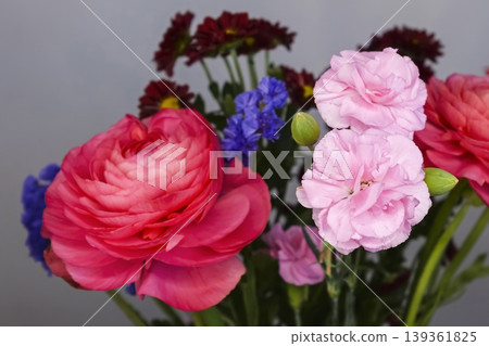 Vibrant bouquet with pink ranunculus, light pink carnation and vivid orange gerbera, creating a bright Mothers Day composition Vibrant bouquet with pink ranunculus, light pink carnation and vivid orange gerbera, creating a bright Mothers Day composition 139361825