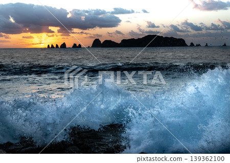 Sunrise and crashing waves off the coast of Nanatsu-iwa in the Hyuga Sea, Nichinan City, Miyazaki Prefecture. 139362100