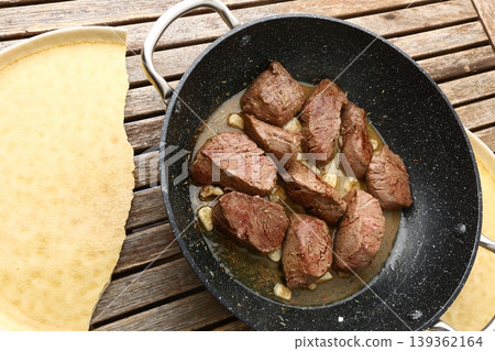 Beef Meat Cooking in Pan with Garlic and Juices Beef Meat Cooking in Pan with Garlic and Juices 139362164