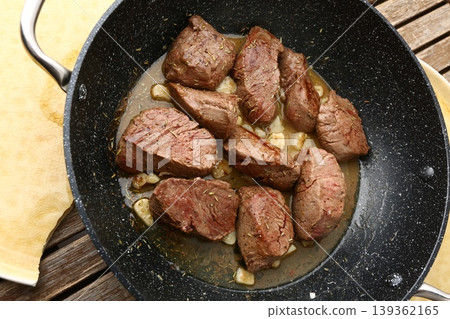 Beef Meat Cooking in Pan with Garlic and Juices Beef Meat Cooking in Pan with Garlic and Juices 139362165