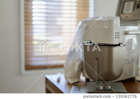 家用麵包機的麵包桶正在電子秤上秤重。 139362776