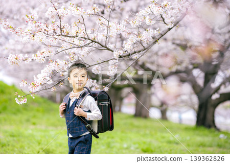 A boy carrying a school bag A boy carrying a school bag 139362826