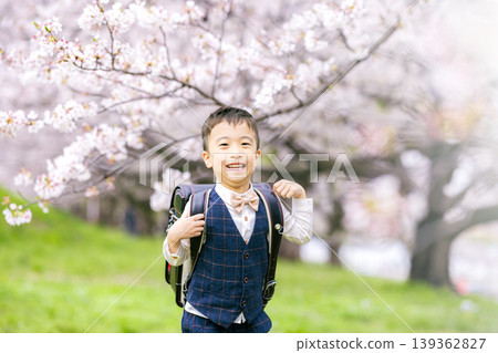 A boy carrying a school bag A boy carrying a school bag 139362827