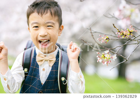 A boy carrying a school bag A boy carrying a school bag 139362829